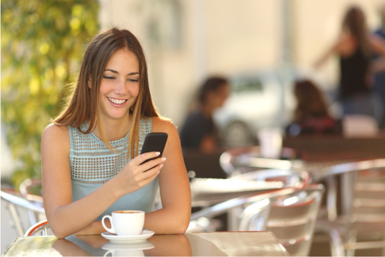Professional using a smartphone for mobile connectivity while working remotely